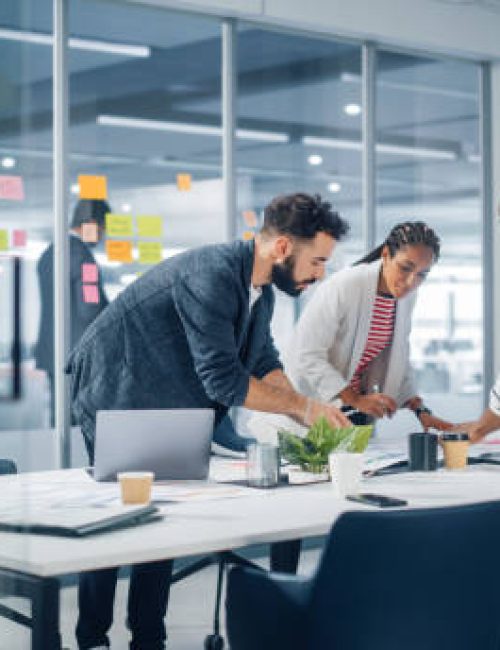 Diverse Team of Professional Businesspeople Meeting in the Office Conference Room. Creative Team Around Table, Black Businesswoman, African-American Digital Entrepreneur and Hispanic CEO Talking.